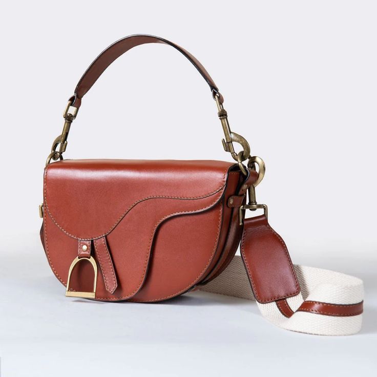 Discover refined elegance in our premium leather collection. From iconic handbags to rugged bracelets and timeless chokers, each piece reflects classic equestrian craftsmanship and enduring EQ chic. Shop now to indulge in URBAN-EQUESTRIAN's signature luxury. Luxury Saddle Shoulder Bag With Brass Hardware, Saddle Bag With Detachable Strap For Daily Use, Vintage Leather Bags With Horsebit Detail, Luxury Cognac Saddle Bag For Daily Use, Vintage Shoulder Bag With Horsebit Detail, Vintage Shoulder Bag With Horsebit Detail For Everyday, Brown Saddle Bag With Detachable Strap, Luxury Cognac Saddle Satchel Bag, Saddle Shoulder Bag With Detachable Handle For Everyday Use