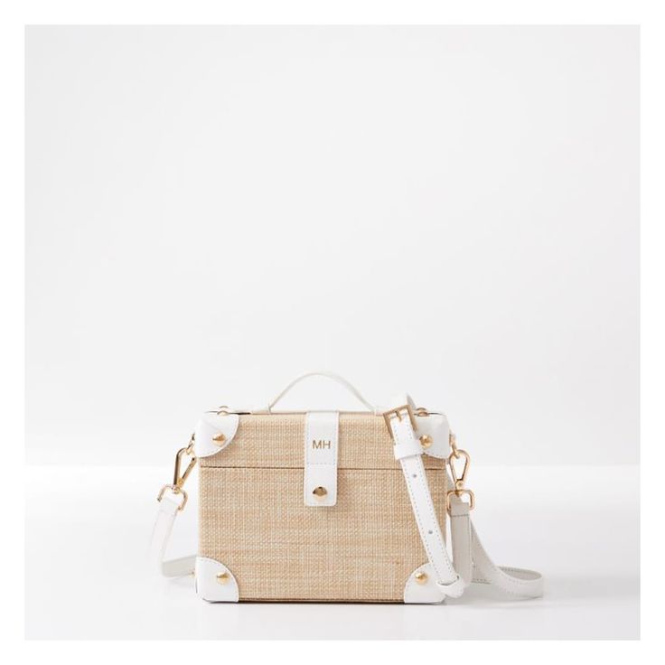 Taking inspiration from Yachting expeditions and vintage travel trunks, the Montauk Crossbody is a versatile hard shell bag, with magnetic closure, leather detailing and a touch of classic style. It features a raffia exterior and striped cotton lining.    7.5"w x 3"d x 5.5"h  Handle drop: 1.5"  Detachable strap: 41"- 49"l  MDF, woven raffia exterior, polyester twill lining, polyurethane leather, gold-toned hardware.  Clean with a soft damp cloth.  Imported.  Monogramming is foil debossed. Beige Rectangular Beach Bag With Detachable Handle, Beige Woven Top Handle Beach Bag, Luxury Handwoven Beach Bag With Top Handle, Chic Cream-colored Top Handle Straw Bag, Eco-friendly Rectangular Beach Bag With Top Handle, Shell Bag, Travel Trunk, Leather Detailing, Woven Raffia