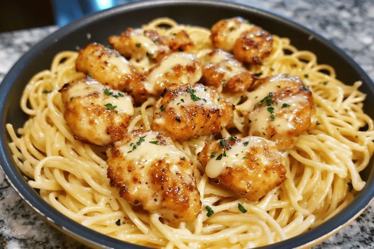 pasta with chicken and sauce in a bowl