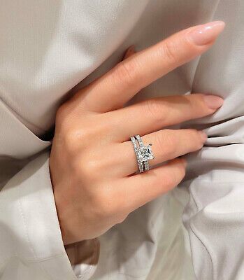 a woman's hand wearing a diamond ring