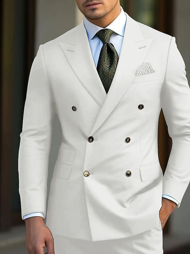 a man wearing a white suit and tie