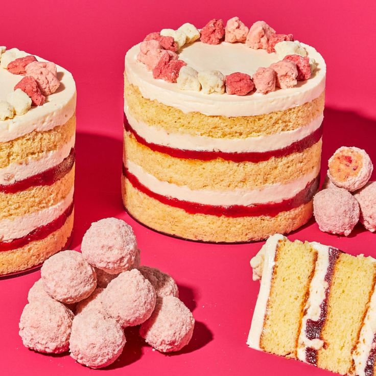 two cakes, one with white frosting and the other with raspberry filling