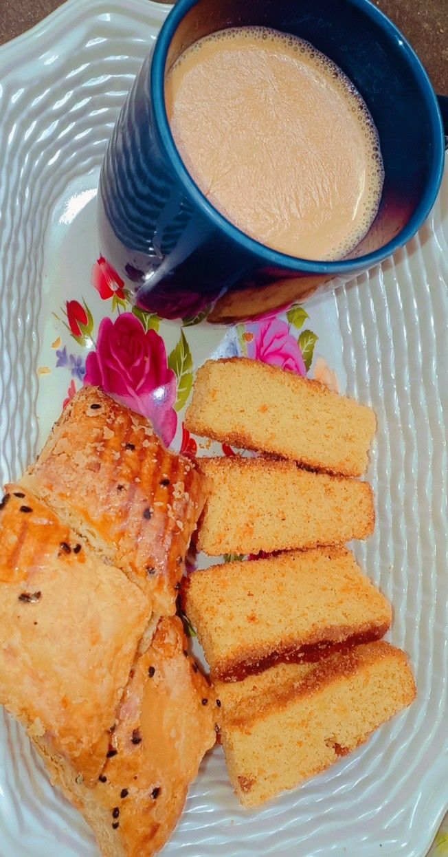 there is a plate with bread and coffee on it