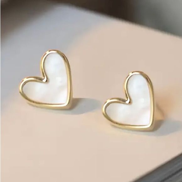 Beautiful Swirly White Tilted Heart Gold Toned Stud Earrings. Playful And Fun! Also Available In Red. See My Other Listings For More Jewelry. Bundle And Save On Shipping. E243 Trendy Heart-shaped Earrings For Anniversary, White Earrings For Valentine's Day Party, Trendy Heart-shaped Anniversary Earrings, White Heart Pendant Earrings For Valentine's Day, Trendy White Double Heart Jewelry, White Earrings With Heart Charm As Gift, White Heart Pendant Earrings, White Heart Pendant Earrings For Gifts, White Heart Pendant Earrings As Gift