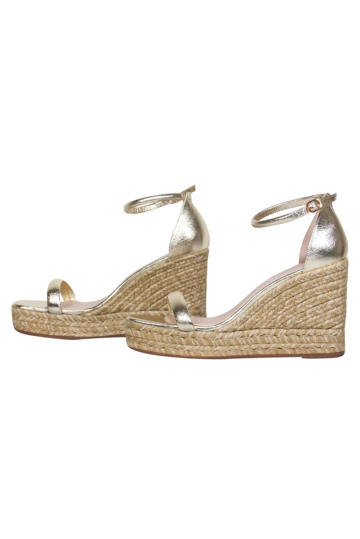 Upgrade your shoe closet with these stylish shimmering espadrilles! Made in a glimmering gold hue with a single strap across the toe. This comfy and stylish shoe will be sure to add a bit of glamour to your jeans and T-shirt combo! Size 9.5 Made in Spain Open toe Ankle strap Dust bag and box included Heel height 4.5" Gold Flat Heel Sandals For Spring, Metallic Spring Heels, Gold Closed Toe Heels For Spring, Metallic Heels With Branded Heel Counter For Spring, Glamorous Gold Heels For Summer, Elegant Summer Espadrilles With Wedge Heel, Gold Espadrilles For Beach And Spring Season, Gold Espadrilles For Spring Beach Outing, Gold Espadrilles For Beach In Spring