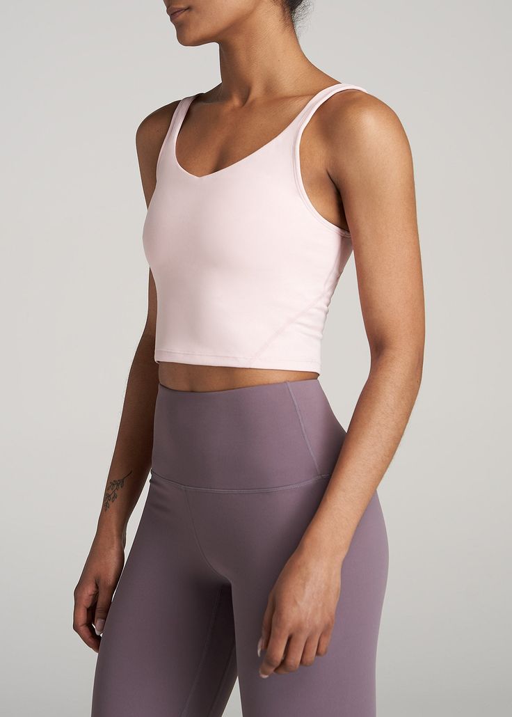 About Our Long Crop Top Quality women's tall tank tops are hard to come by – which is why you'll want this tank from our AT Balance line in every color. With a cropped length that ends just above the natural waist, a scoop back and a fitted style that will flatter your frame, it can be worn everywhere from the Pilates studio to the yoga mat and brunch with friends. This cropped tank top is made of a buttery-soft fabric that's sweat-wicking and lightweight so you can stay comfortable while you wo Bra Friendly Medium Support Crop Top Tank, Sporty Sleeveless Bra Friendly Top, Sleeveless Athleisure Tops Bra Friendly, Athleisure Sleeveless Bra-friendly Tops, Pink Sleeveless Tank Top With Medium Support, Pink Cropped Tank Top With Bra-friendly Design, Bra-friendly Gym Cami Tops, Sleeveless Tops With Built-in Bra And Medium Support, Crop Top Tank Top With Built-in Bra