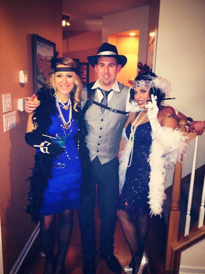 three people dressed in costumes posing for a photo