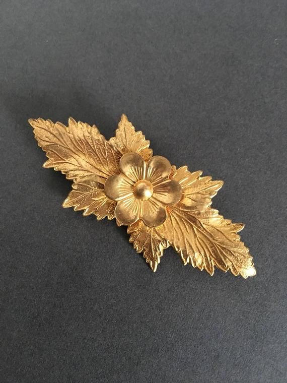 Andriani Vintage is pleased to offer for sale this wonderful  vintage Brooch. A wonderful Gold Gilt Look Brooch PinIn a floral design  with leaves In lovely vintage condition9.5cms.  X 4cms Great unusual items at a very affordable price. Gold Brooch With Flower Decoration For Formal Occasions, Vintage Yellow Gold Brooches For Ceremonial Use, Vintage Yellow Gold Brooches For Ceremonial Occasions, Vintage Yellow Gold Brooch For Ceremonial Use, Ornate Gold Brooches For Vintage Events, Vintage Gold Brooches For Ceremonial Use, Classic Gold Brooches For Vintage Events, Vintage Handmade Gold Lapel Pin, Vintage Gold Handmade Lapel Pin