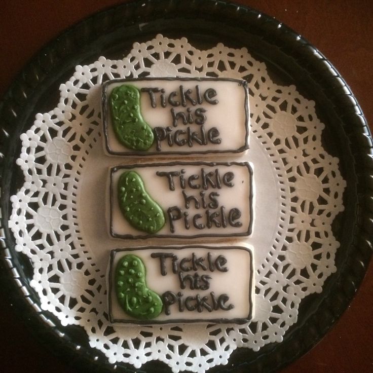 there are three cookies on the plate that say tickle and pickle