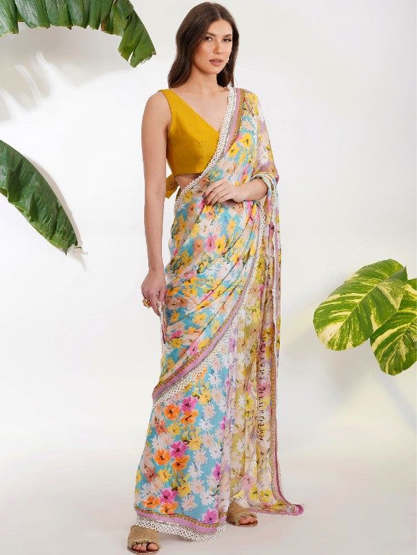 Floral printed saree in satin-georgette with cutdana and pearl border. Comes with an unstitched yellow blouse piece. Color: Mulit color Fabric: Viscose Satin Georgette Blouse piece - Chanderi Embroidery / Work Details: Cutdana and pearl work Note: Wash Care - Dry Clean only The product will be delivered within 3-4 weeks of the order placed Relaxed Fit Trendroots provides a blouse stitching service at extra cost. For blouse, stitching quote email us at info@trendroots.com Georgette Digital Print Blouse Piece For Saree, Unstitched Georgette Blouse Piece With Digital Print, Georgette Blouse Piece With Digital Print For Saree, Georgette Saree Blouse Piece With Digital Print, Digital Print Saree For Wedding And Eid, Wedding Saree With Digital Print For Eid, Georgette Saree With Digital Print In Traditional Drape, Traditional Drape Georgette Blouse Piece With Digital Print, Multicolor Digital Print Saree For Wedding