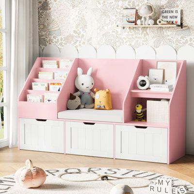 a child's room with pink and white storage bins for books, toys and stuffed animals