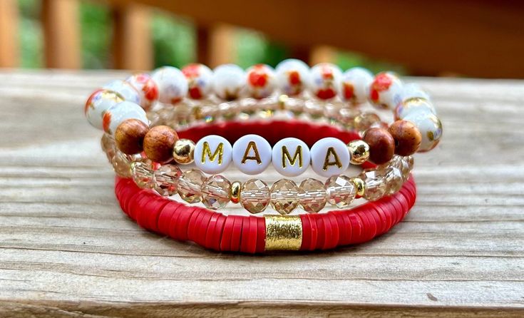 This stack is beautiful! I love the old fashion floral beads, and the red Heishi bracelet!  ♥️This stack consists of three bracelets.  * A floral porcelain and wood bead bracelet. I can add any name or word.  * A red Heishi bracelet with a gold spacer bead.  * A light brown glass bead bracelet with tiny gold spacer discs.  ♥️All gold beads are 14k non-tarnish beads. ♥️{Sizing}  The average size is 7. I can make these in any size! Please see the measurement directions in the item images to get your perfect fit!  ♥️{Personalization}  I can change the wording to any name or word. Please let me know what you want on your bracelet!  Thank you! Red Beaded Bracelets For Everyday Wear, Red Bohemian Bracelets With Letter Beads, Bohemian Red Bracelets With Letter Beads, Everyday Red Stretch Bracelet With Round Beads, Bohemian Round Bead Bracelets For Holiday, Bohemian Letter Beads Bracelets For Mother's Day, Red Bohemian Jewelry With Letter Beads, Bohemian Red Jewelry With Letter Beads, Red Bohemian Beaded Bracelets For Everyday