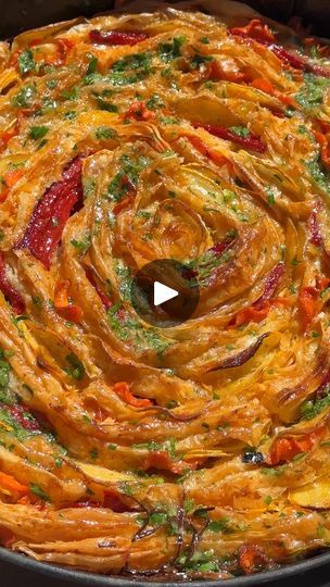 a pan filled with pasta and vegetables on top of a stove