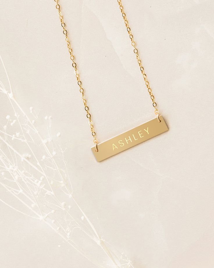 The daintiness of our personalized name necklace adds the perfect touch to any outfit! The simplicity of this custom necklace allows you to mix and match with a variety of styles to create an elegant look. Beautifully engraved, this customized piece makes the perfect gift for Valentine’s Day, Mother’s Day, Christmas and all special occasions and milestones!Material: 14k gold filled, anti-tarnish material (will not turn blue or green and will not stain skin)Bar Size: 1.25” W x 0.25” HChain Length Customizable Minimalist Rose Gold Necklace, Minimalist Customizable Rose Gold Necklace, Elegant Rectangular Name Necklace, Customized Rose Gold Minimalist Name Necklace, Customized Minimalist Rose Gold Name Necklace, Elegant Necklaces With Custom Text For Gift, Minimalist Nameplate Bar Necklace For Anniversary, Minimalist Custom Name Bar Necklace For Anniversary, Minimalist Nameplate Necklace