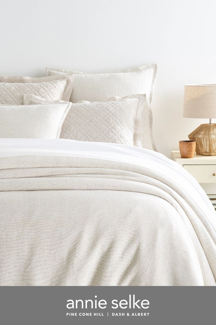 an image of a bed with white linens and pillows in the bedroom or hotel room