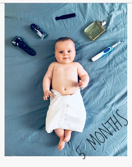 a baby laying on top of a blue blanket