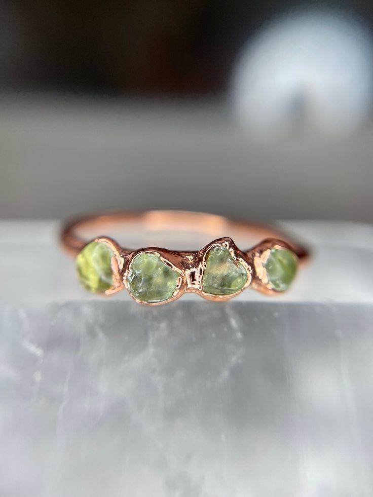 Peridot Ring // August Birthstone // Raw Peridot and Copper Electroformed Rings // Raw Stone Ring // Compassion Ring // Chartreuse Ring This listing is for one ring. Peridot, the August Birthstone, is a stone of compassion. It has a friendly energy and is excellent for healing. It assists in rebirth and renewal of all kinds. Peridot also brings abundance and prosperity. Each stone and ring is unique, just like you are so allow for variation in color and size. Your ring will come in a little box Green Peridot Stackable Promise Rings, Raw Peridot, Green Stackable Rings With Accent Stones For May Birthstone, Peridot Engagement Rings, Peridot Gemstone Stackable Rings For May Birthstone, Electroformed Ring, Stackable Peridot Gemstone Rings For May Birthstone, Green Peridot Stackable Rings, Stackable Peridot Promise Ring