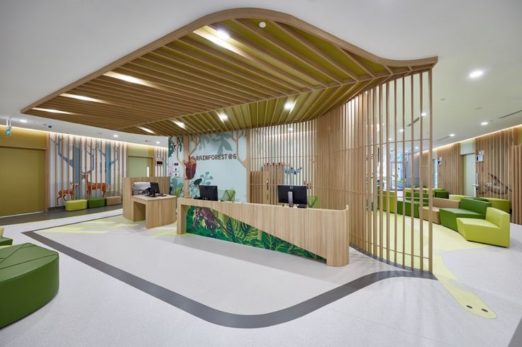 an office lobby with green and yellow furniture