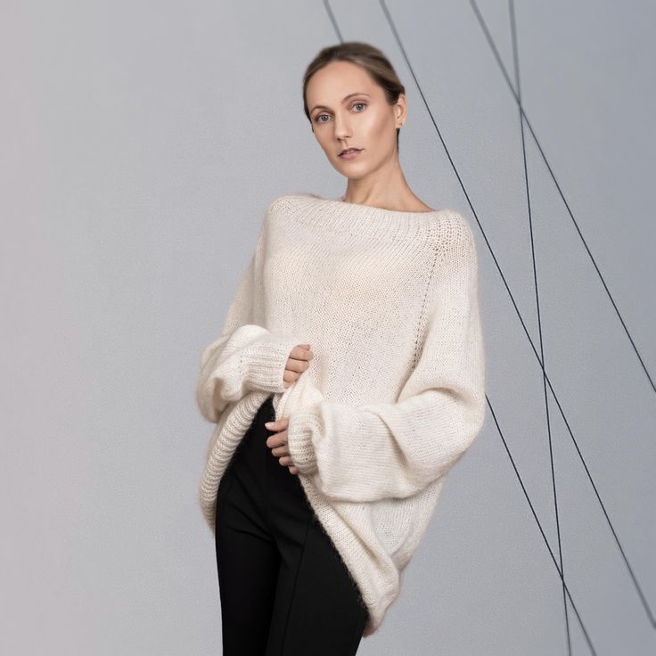 The versatile, luxurious, and elegant silhouette of the sweater ASTRID can be a part of many different looks, at the same time keeping you warm and cosy.  Hand-crafted from premium alpaca and mohair blend, this fluffy pullover features an oversized fit, raglan shoulder construction and extra-long sleeves. Style with jeans for a more casual look, or elegant trousers/skirt for an evening. DETAILS -Oversized -Boat neck -Extra-long puff sleeve -Raglan shoulder construction Designed and ethically mad Elegant Cream Soft Knit Sweater, Elegant Oversized Long Sleeve Sweater, Classic Long Sleeve Mohair Sweater, Elegant Oversized Soft Knit Tops, Elegant Oversized White Sweater, Oversized Elegant Knit Sweater, Elegant Oversized Knit Sweater, Chic Balloon Sleeve Sweater For Winter, Elegant Mohair Crew Neck Sweater