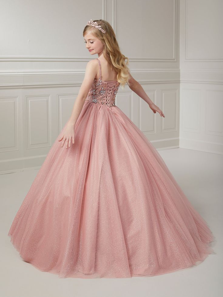 Your sweet girl will make a grand entrance in this bead embroidered long sleeveless illusion dress with A-line tulle skirt by Tiffany Princess 13723. This sleeveless gown features an illusion scoop neck sweetheart bodice with floral beaded embellishments, A-line sparkle tulle skirt, sweep train, and a lace-up back. House of Wu Tiffany Princess Collection Fall 2023 Style Number: 13723 Fabric: Floral Beading/Sparkle Tulle Please note: There may be a loss of glitter while wearing this dress due to Beaded Embellishments, Princess Collection, Sleeveless Gown, Illusion Dress, Grand Entrance, Fabric Floral, Fall 2023, Formal Gowns, Sweet Girls