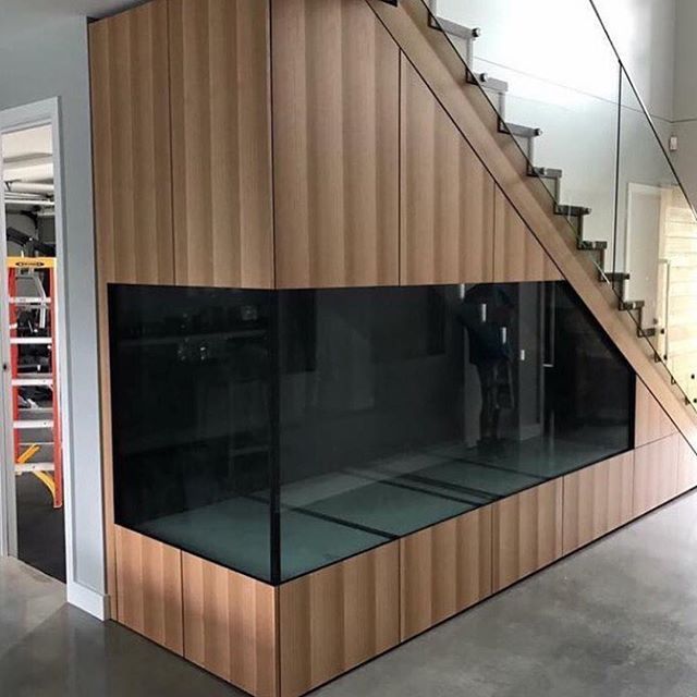 the inside of a building with glass walls and stairs