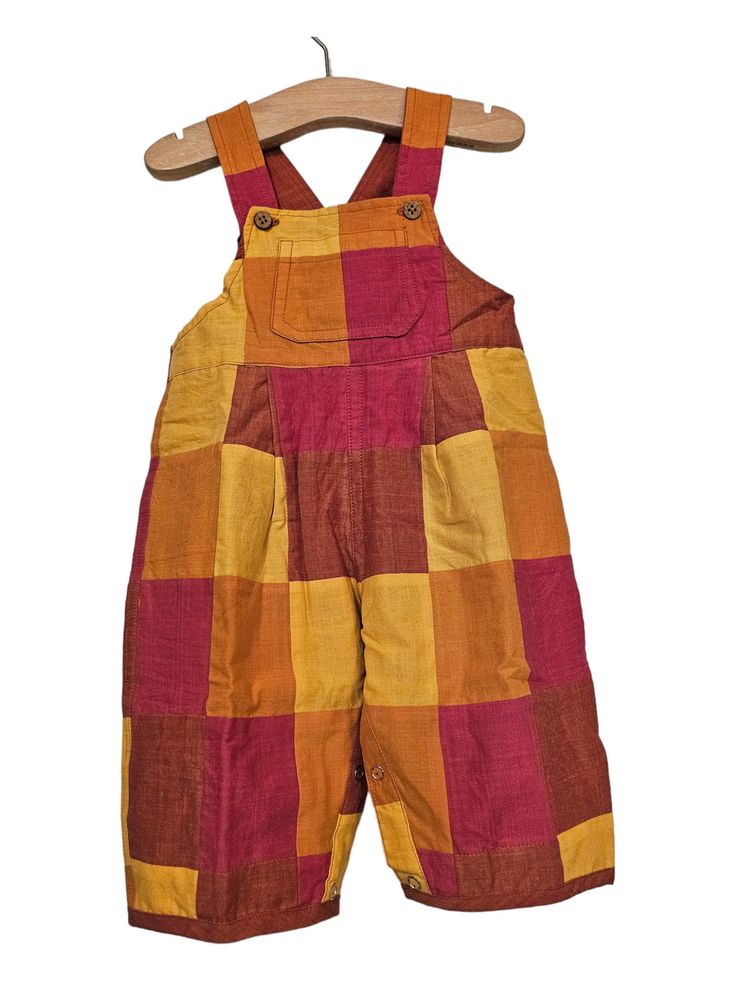 Red & Orange Patchwork Baby Dungarees These dungarees are made from handwoven patchwork fabric in a combination of vibrant reds, oranges and yellows.  We've made our dungarees fully reversible...so you get two outfits in one. The inside fabric is a beautiful earthy terracotta and the buttons are made from natural coconut shell. We believe in sustainable fashion. Our dungarees are made to grow with your child. The leg can be rolled down as your child grows. The  extendable  button fasting shoulder straps and elasticated back allow for a comfy fit,  growth and cloth nappies. The legs have poppers for an easy nappy change and there is a patch pocket on the front for added detail.  We believe that the most beautiful things are crafted slowly, with care and by hand.  Our founder, Jaki, set the Red Bib Front Overalls With Pockets, Red Cotton Overalls For Summer, Red Cotton Summer Overalls, Multicolor Cotton Overalls With Patchwork, Earthy Terracotta, Baby Dungarees, Nappy Change, Patchwork Baby, Cloth Nappies