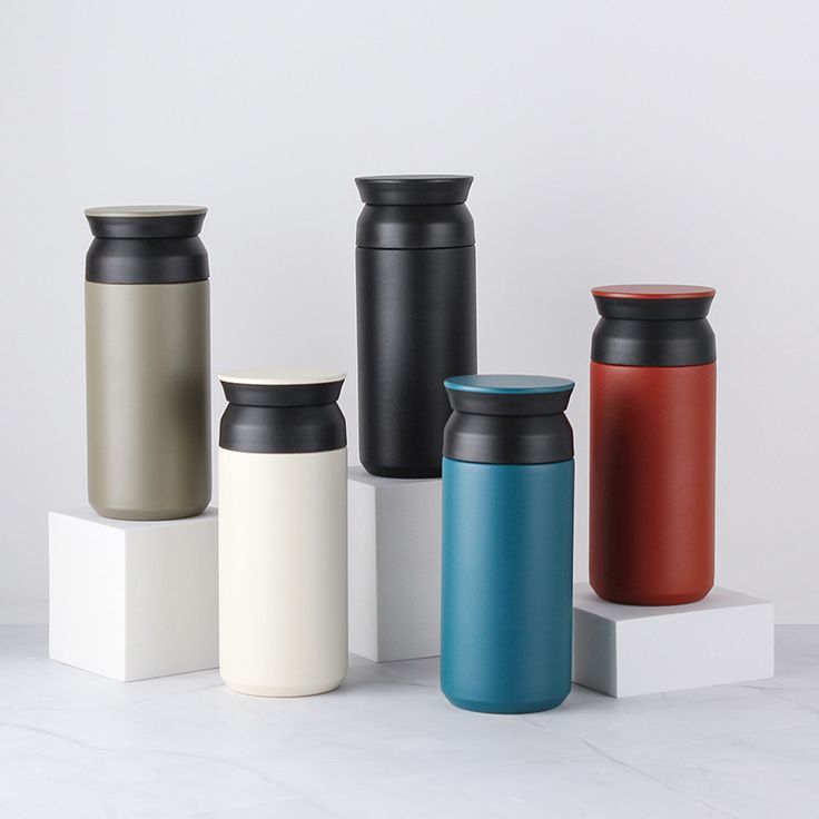 thermos are lined up on top of each other in different colors and sizes