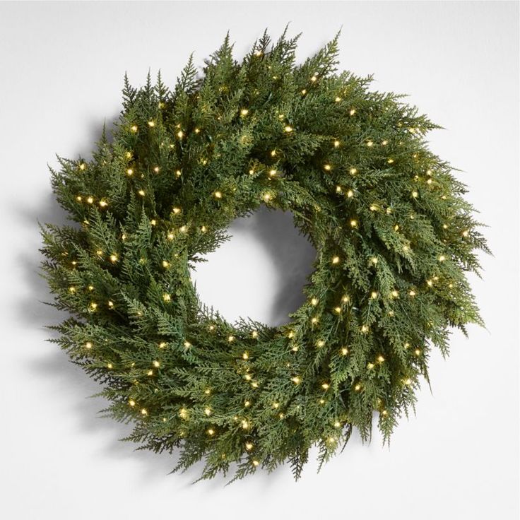 a christmas wreath with lights hanging from it