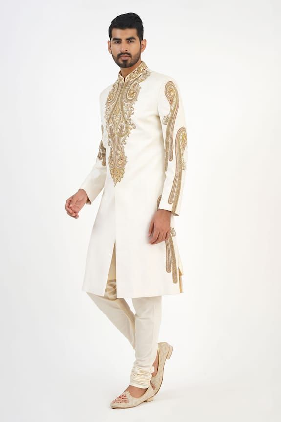 Ivory matka silk sherwani with dabka, beads and french knots hand embroidered motifs. Comes with churidar and a kurta. - Aza Fashions Elegant Churidar With Gold Embroidery For Eid, Elegant Gold Embroidered Churidar For Eid, Festive Cream Traditional Wear With Gold Embroidery, Bollywood Style Raw Silk Sherwani With Gold Embroidery, Off White Embroidered Traditional Wear For Reception, Off White Bandhgala With Dabka For Eid, Elegant Raw Silk Sherwani With Gold Embroidery, Embroidered Off White Traditional Wear For Reception, Embroidered Off-white Traditional Wear For Reception