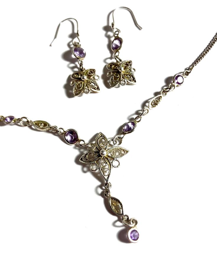 "Vintage amethyst gemstone & sterling silver lavalier necklace with earrings set. Pretty and petite purple amethyst necklace and earrings set with filligree in a flower pattern. Necklace measures 18.25\" long (extender chain included) with a 1.5\" drop length. Earrings measure 2.5\" long x 1cm wide with a .75\" drop length. The necklace & earrings are sterling silver throughout. The spring ring works perfect and is stamped 925, the earrings hooks are not stamped but are solid sterling silver also as I have been added them.  Professionally cleaned and ready to wear." Elegant Purple Jewelry For Formal Occasions, Elegant Filigree Jewelry Sets, Fine Purple Jewelry For Formal Occasions, Sterling Silver Pendant Jewelry Set For Formal Occasions, Purple Earrings With Intricate Design For Gift, Purple Earrings With Intricate Design As Gift, Elegant Purple Jewelry Sets For Formal Occasions, Fine Jewelry With Filigree Dangle, Costume Jewelry Sterling Silver Pendant