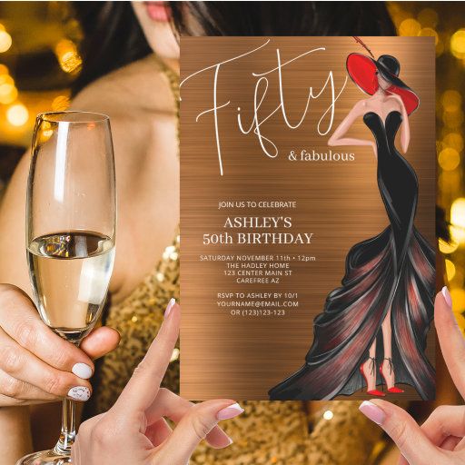 a woman holding a glass of wine and a card with the words fifty and fabulous on it