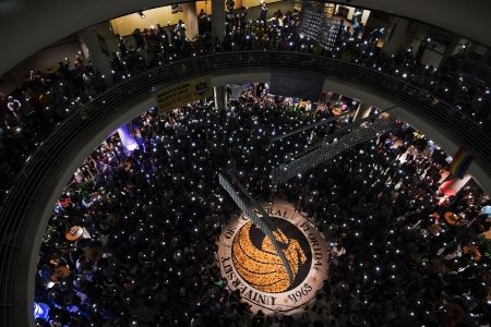 an overhead view of a large group of people in a building with a clock on it