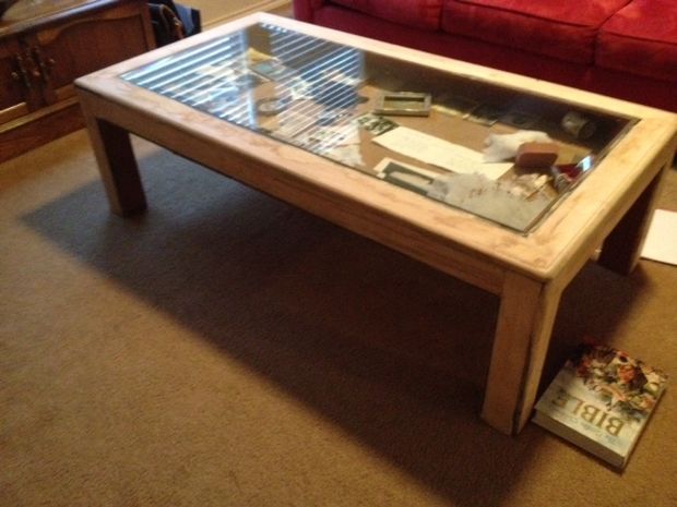 a coffee table with glass top in a living room