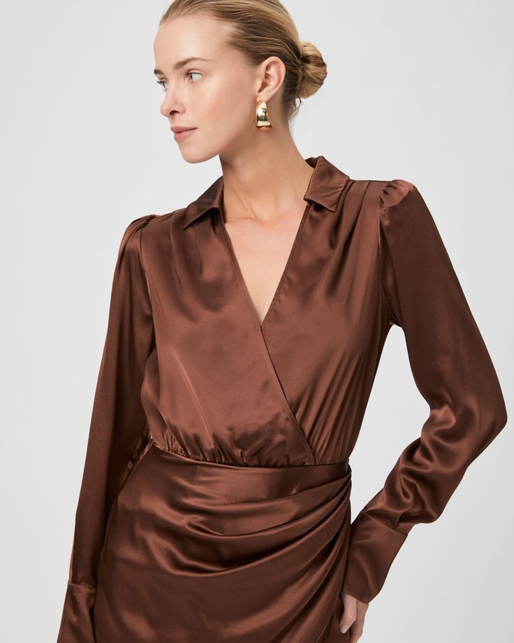 Made from 100% silk satin, the Nyla dress is a flattering long sleeve faux-wrap mini dress that features a collar with a v-neckline. This chic brown dress will be your new favorite date night staple. | Nyla Dress - Landslide Silk Satin | Size 14 Silk V-neck Mini Dress For Work, Silk V-neck Dress For Fall, Chic V-neck Satin Dress For Fall, Fall Cocktail Wrap Dress With Surplice Neckline, Sleek Long Sleeve Satin Dress For Date Night, Long Sleeve Satin Dress For Fall Date Night, Elegant Fall Mini Dress In Satin, Elegant Satin Mini Dress For Fall, Fall Long Sleeve Satin Dress For Date Night