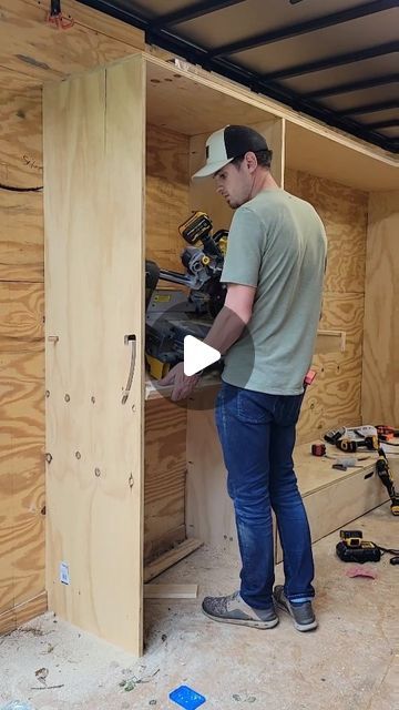 a man is working on some wood in his garage