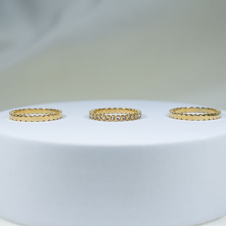 elevate your ring stack with our Sunset Lover Ring Stack. this premium set creates endless possibilities to elevate your jewelry capsule collection. wear each band individually or stack them together for a touch of luxury. the perfect addition for a sophisticated and minimal look. 18K gold pvd over 316L stainless steel water & tarnish resistant each band is 2mm thick set of 3 bands 1 cz bezel band, 2 solid bands Minimal Look, Sunset Lover, Stacking Rings, 18k Gold, Band, Gold