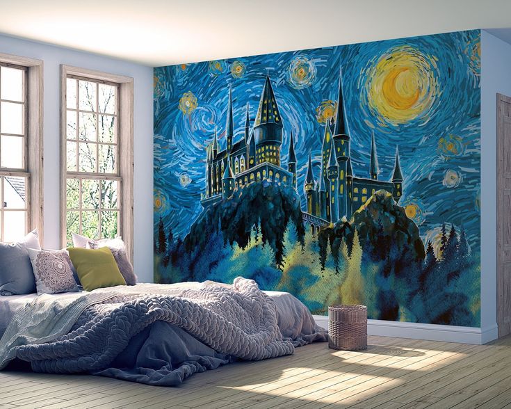 a bedroom with a hogwarts castle mural painted on the wall next to it