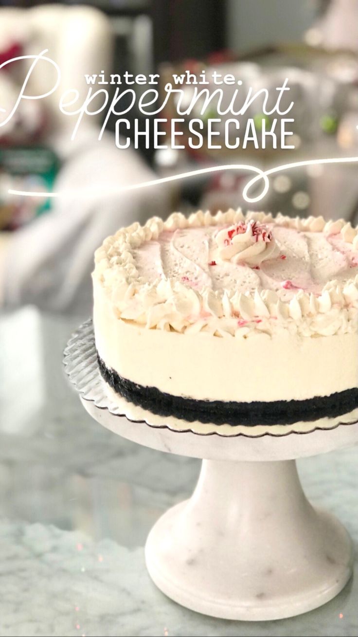 a white cake with peppermint and cheesecake frosting sitting on a table