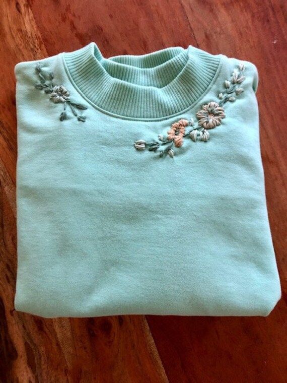 This soft sweatshirt is designed with modern embroidered flowers. A cozy sweatshirt that is great for wfh or paired with jeans and boots for a great spring look. Cozy Cotton Sweatshirt For Spring, Spring Fleece Sweatshirt With Ribbed Cuffs, Spring Cotton Sweater With Floral Applique, Fall Floral Applique Crew Neck Sweater, Comfortable Fleece Tops For Spring, Trendy Embroidered Cotton Sweater, Comfortable Cotton Sweatshirt For Spring, Cozy Cotton Sweater For Spring, Spring Embroidered Cotton Sweater