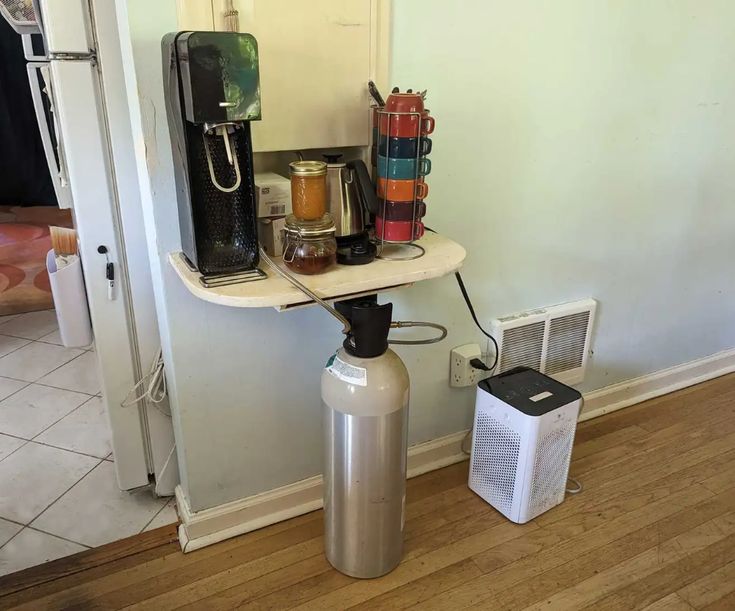 there is a coffee maker on the table next to an air puke heater