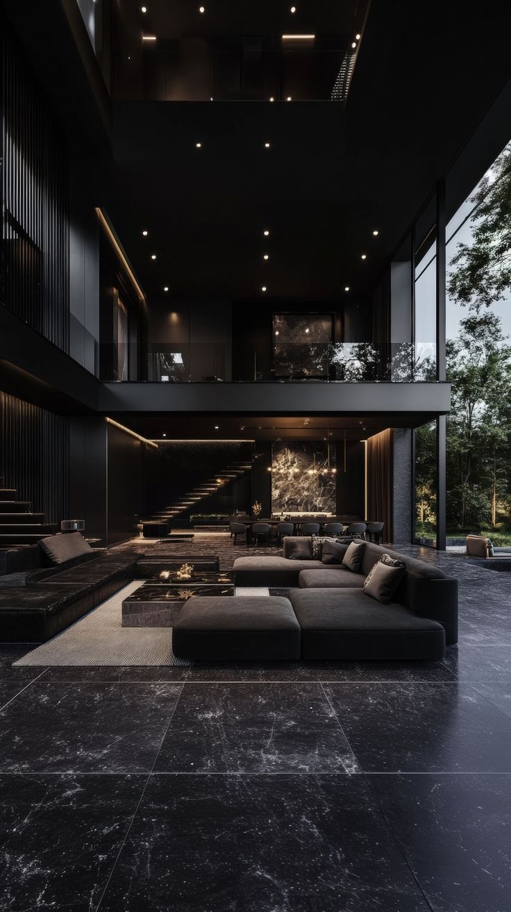 a living room filled with lots of black furniture