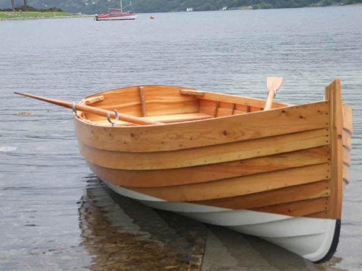 a small wooden boat sitting in the water