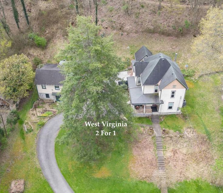 an aerial view of a home in west virginia, showing the driveway and two trees