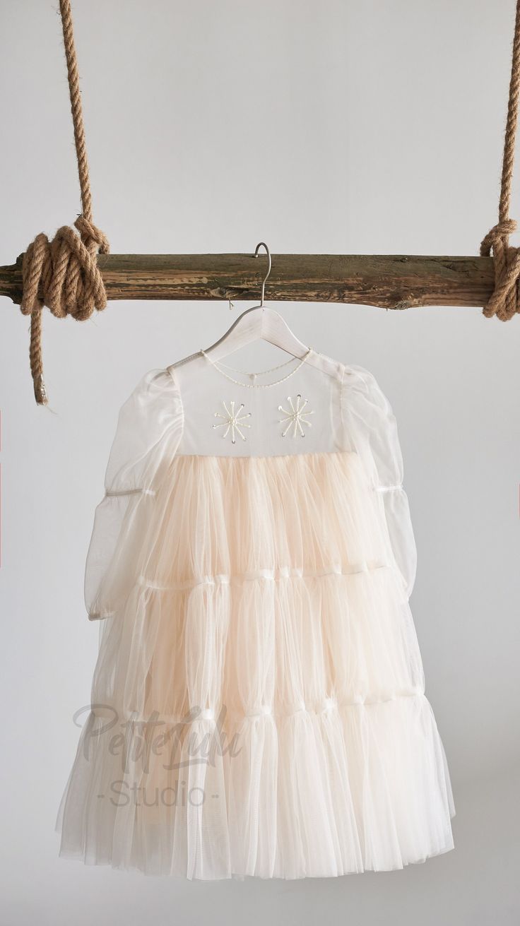 Ooh lálá, très chic! Your little lady will surely receive lots of compliments on this fine, handmade dress - ideal for flower girls at weddings or for any other important occasions where she'd like to dress to impress! Thanks to a handy zipper on the back, putting on this dress is easy as pie! * Top: Illusion tulle neckline decorated with beads. Two beaded flowers on the chest. Long Tull sleeves for an airy look. * Skirt: Two layers of soft champagne tulle in knee length. * Thanks to a handy zip Cream Fitted Princess Dress For Wedding, Elegant Bridesmaid Princess Dress With Floral Applique, Elegant Floral Applique Tutu Dress For Wedding, Elegant Tulle Tutu Dress With Floral Applique, Elegant Cream Princess Dress With Tulle Skirt, Elegant Wedding Tutu Dress With Floral Applique, Elegant Cream Tulle Princess Dress, Cream Wedding Dress With Floral Applique, Elegant White Tutu Dress With Floral Applique