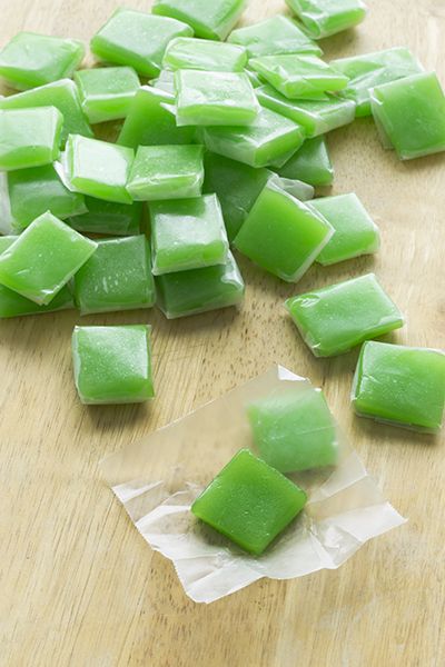 chopped up green food sitting on top of a wooden cutting board