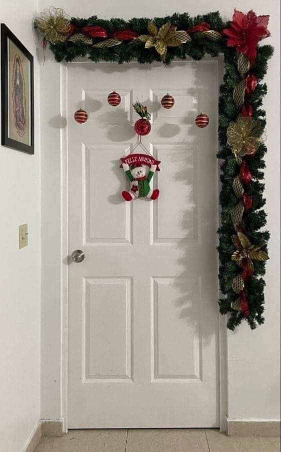 a white door decorated with christmas decorations