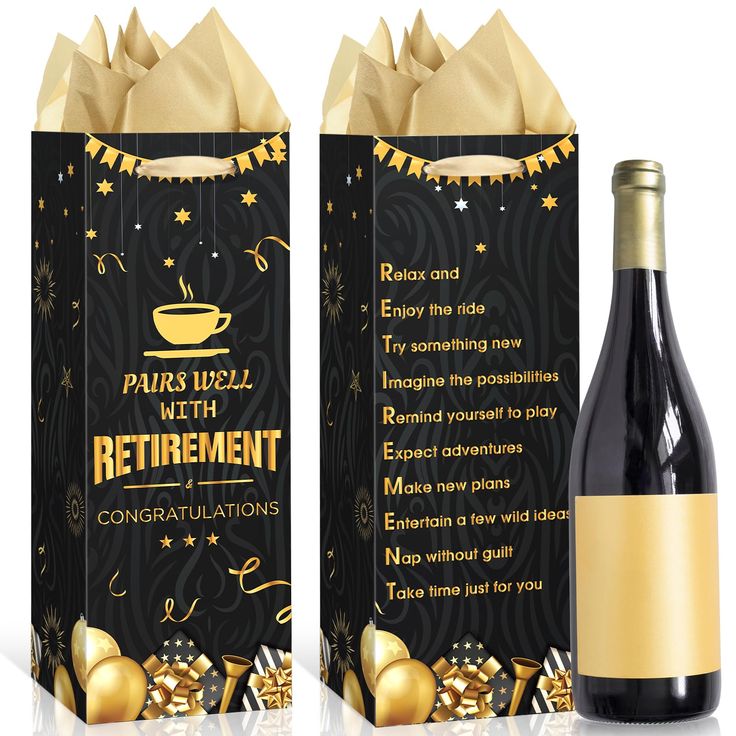 a bottle of wine next to a black box with gold foil decorations and a golden ribbon