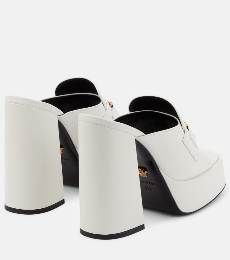 Medusa Leather Mules in White - Versace | Mytheresa Luxury High Heel Calf Leather Mules, White Luxury Calf Leather Mules, Luxury White Calf Leather Mules, Luxury High Heel Clogs With Leather Sole, Designer Square Toe Mules With Branded Insole, Designer Slip-on Mules With Sculpted Heel, Designer Mules With Branded Insole And Square Toe, Modern Mules With Leather Footbed And Square Toe, Designer Calf Leather Mules With Sculpted Heel