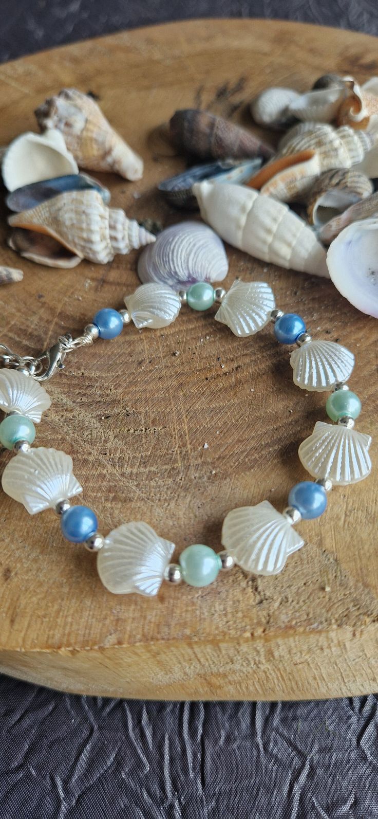 Ivory shell and blue bead beach/holiday themed bracelet   This handmade beaded adult's bracelet is approximately 22cm in total length with an adjustable chain. It is built on a silver wire for strength with silver findings.  These are the perfect little gifts for a wedding, anniversary, prom  ,birthday, festival or simply to wear on your holiday.  Dispatched within 1-3 days by royal mail postage. Free postage to the UK. Presented and gift wrapped in luxury tissue paper and a gift bag.  Please me Blue Bead Bracelet, Prom Birthday, Birthday Festival, Blue Beaded Bracelets, Beach Holiday, Blue Beads, Bead Bracelet, Silver Wire, Tissue Paper