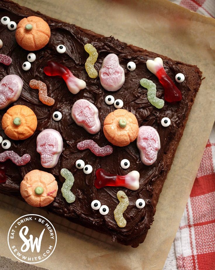 a chocolate cake decorated with eyes and candy